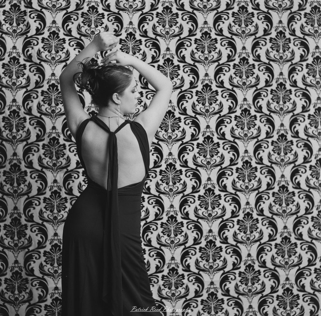 A vintage fashion portrait of Jinx, photographed on medium format film using a Mamiya C33. The session combines classic styling with the tonal depth and softness of analog photography, creating a timeless studio portrait inspired by mid-century fashion aesthetics.