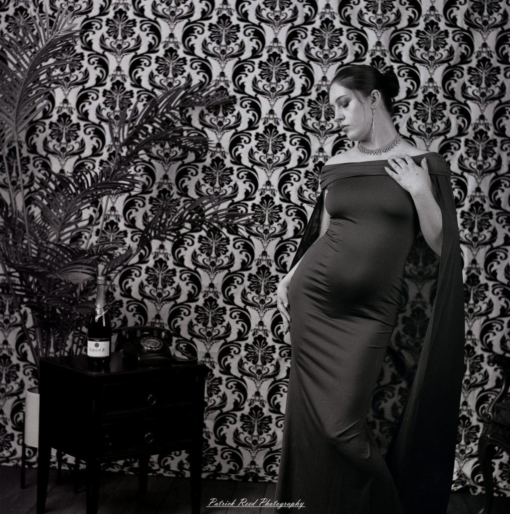 A vintage fashion portrait of Jinx, photographed on medium format film using a Mamiya C33. The session combines classic styling with the tonal depth and softness of analog photography, creating a timeless studio portrait inspired by mid-century fashion aesthetics.