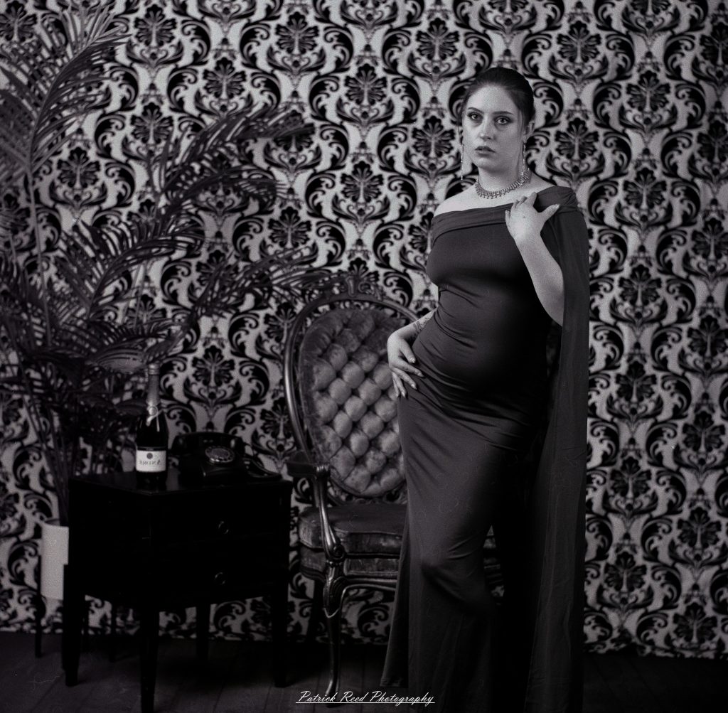 A vintage fashion portrait of Jinx, photographed on medium format film using a Mamiya C33. The session combines classic styling with the tonal depth and softness of analog photography, creating a timeless studio portrait inspired by mid-century fashion aesthetics.