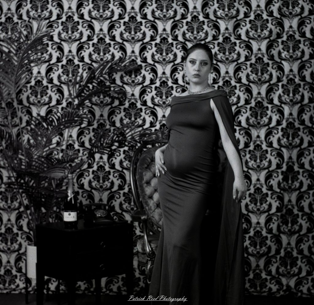 A vintage fashion portrait of Jinx, photographed on medium format film using a Mamiya C33. The session combines classic styling with the tonal depth and softness of analog photography, creating a timeless studio portrait inspired by mid-century fashion aesthetics.