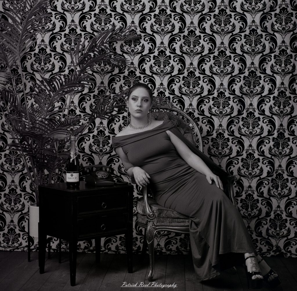 A vintage fashion portrait of Jinx, photographed on medium format film using a Mamiya C33. The session combines classic styling with the tonal depth and softness of analog photography, creating a timeless studio portrait inspired by mid-century fashion aesthetics.