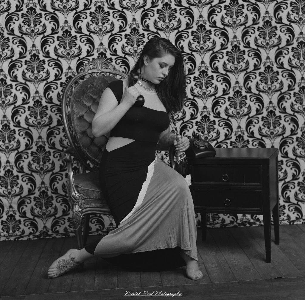 A vintage fashion portrait of Jinx, photographed on medium format film using a Mamiya C33. The session combines classic styling with the tonal depth and softness of analog photography, creating a timeless studio portrait inspired by mid-century fashion aesthetics.