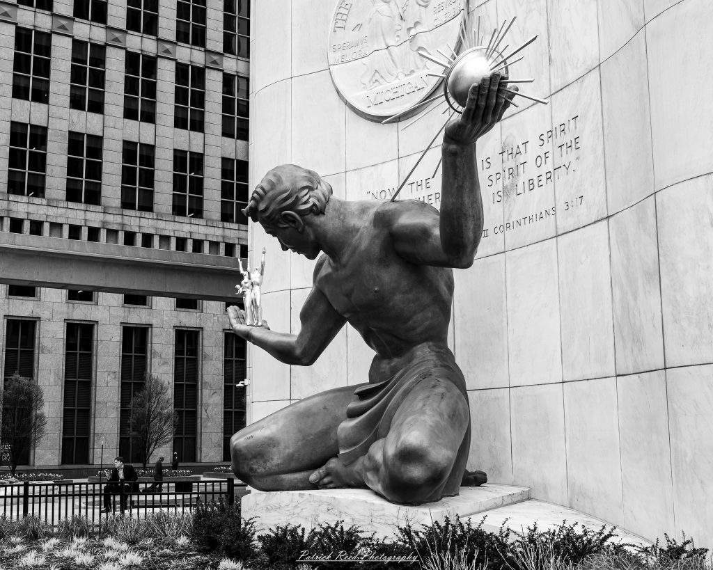 Black and white street photography in downtown Detroit, Michigan capturing urban architecture, city life, public art, and Detroit riverfront scenes in a documentary photography style.