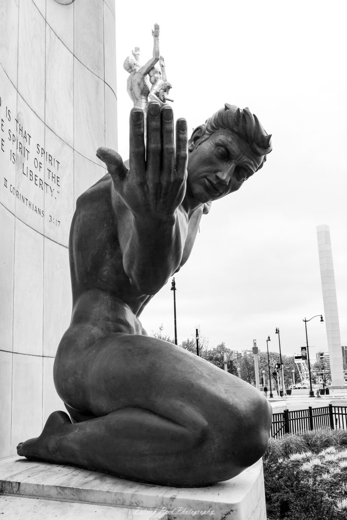 Black and white street photography in downtown Detroit, Michigan capturing urban architecture, city life, public art, and Detroit riverfront scenes in a documentary photography style.