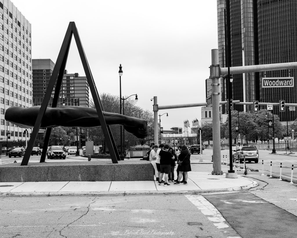 Black and white street photography in downtown Detroit, Michigan capturing urban architecture, city life, public art, and Detroit riverfront scenes in a documentary photography style.