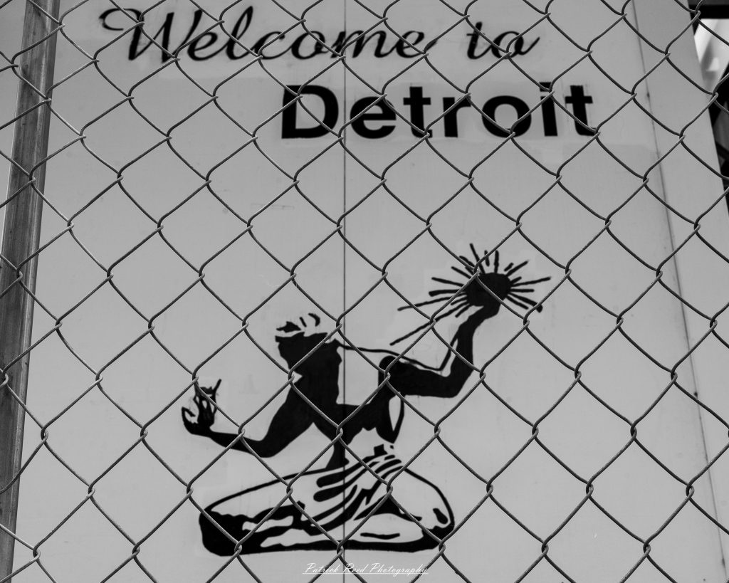 Black and white street photography in downtown Detroit, Michigan capturing urban architecture, city life, public art, and Detroit riverfront scenes in a documentary photography style.