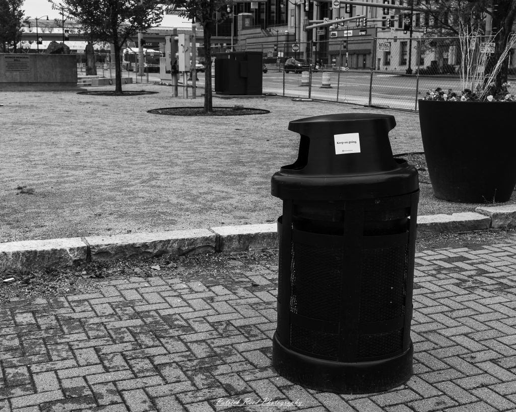 Black and white street photography in downtown Detroit, Michigan capturing urban architecture, city life, public art, and Detroit riverfront scenes in a documentary photography style.