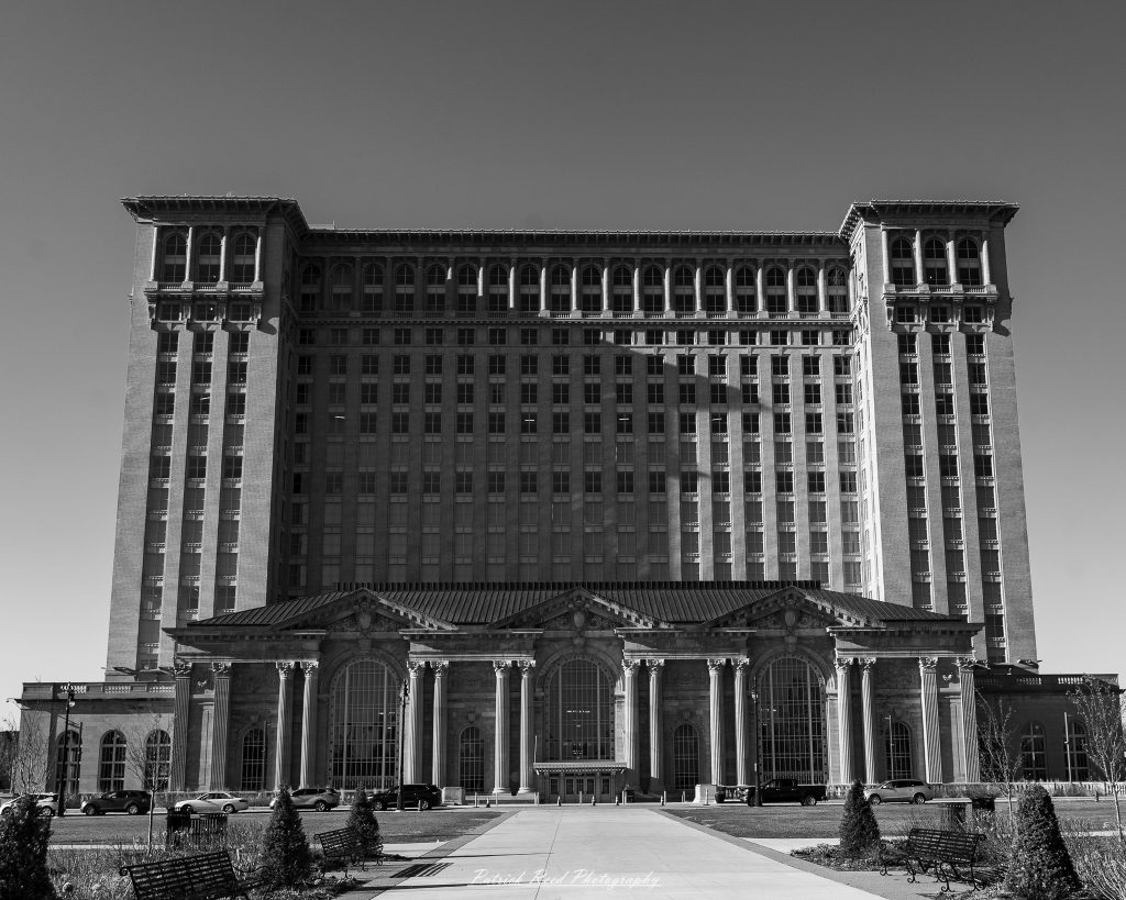 Black and white street photography in downtown Detroit, Michigan capturing urban architecture, city life, public art, and Detroit riverfront scenes in a documentary photography style.