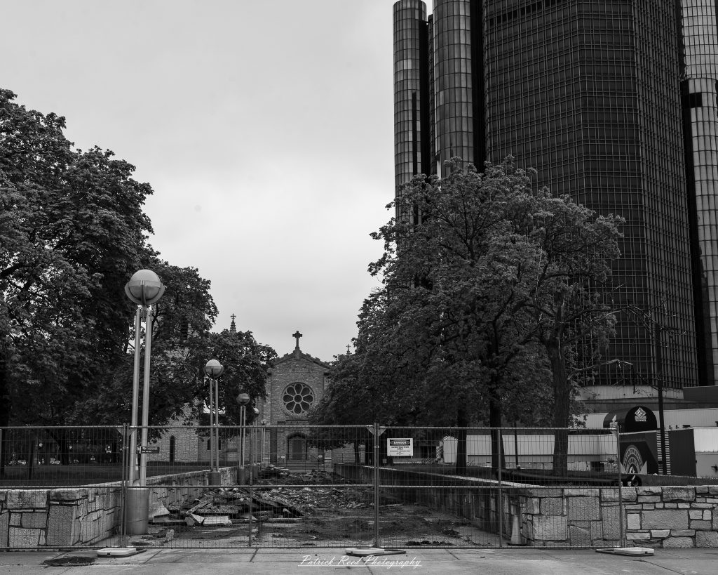 Black and white street photography in downtown Detroit, Michigan capturing urban architecture, city life, public art, and Detroit riverfront scenes in a documentary photography style.