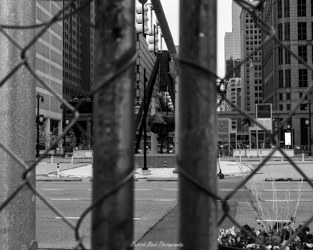 Black and white street photography in downtown Detroit, Michigan capturing urban architecture, city life, public art, and Detroit riverfront scenes in a documentary photography style.