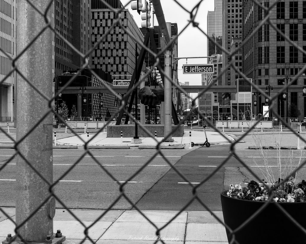 Black and white street photography in downtown Detroit, Michigan capturing urban architecture, city life, public art, and Detroit riverfront scenes in a documentary photography style.