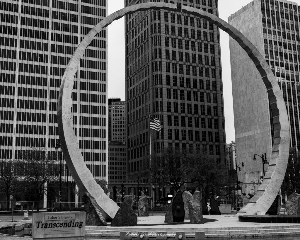 Black and white street photography in downtown Detroit, Michigan capturing urban architecture, city life, public art, and Detroit riverfront scenes in a documentary photography style.