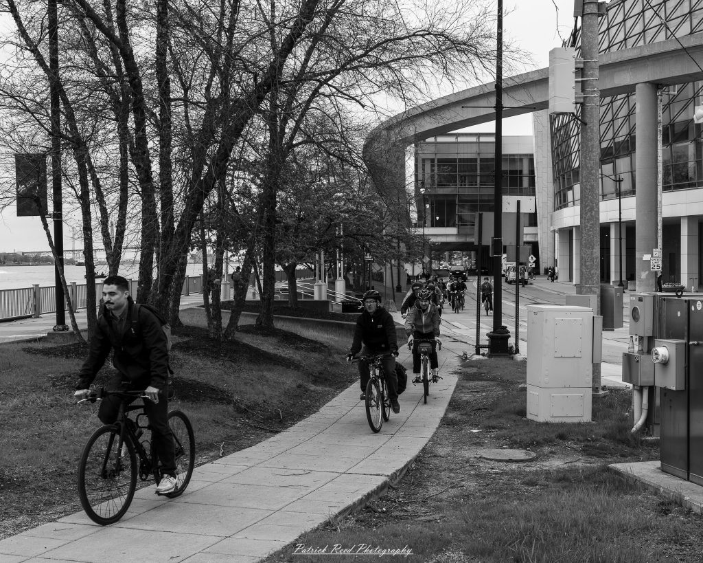 Black and white street photography in downtown Detroit, Michigan capturing urban architecture, city life, public art, and Detroit riverfront scenes in a documentary photography style.