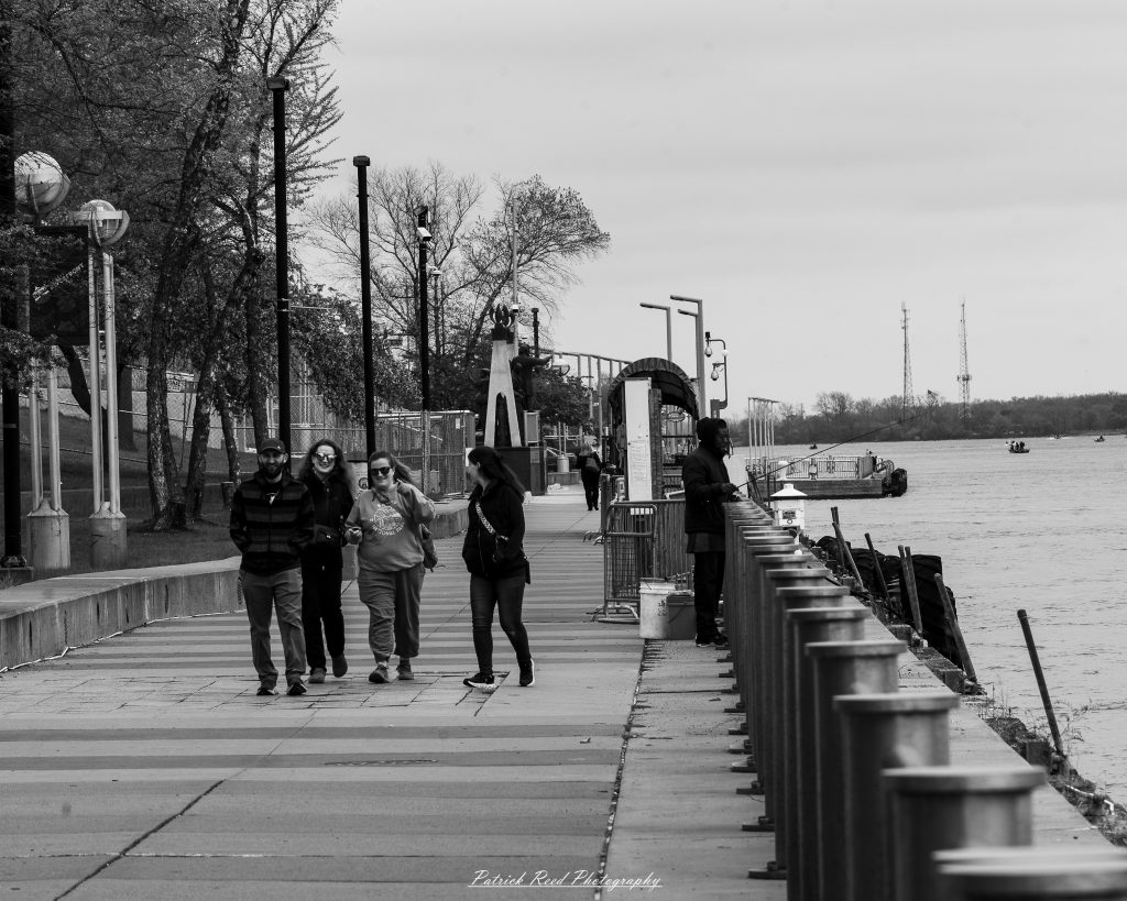 Black and white street photography in downtown Detroit, Michigan capturing urban architecture, city life, public art, and Detroit riverfront scenes in a documentary photography style.