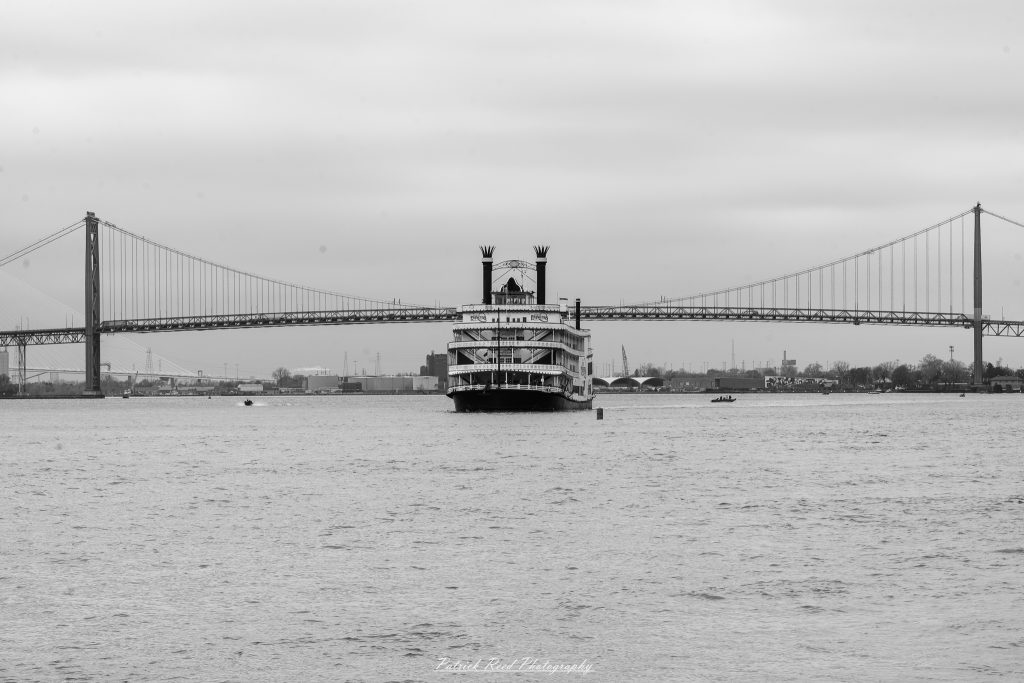 Black and white street photography in downtown Detroit, Michigan capturing urban architecture, city life, public art, and Detroit riverfront scenes in a documentary photography style.
