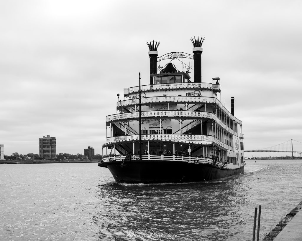 Black and white street photography in downtown Detroit, Michigan capturing urban architecture, city life, public art, and Detroit riverfront scenes in a documentary photography style.