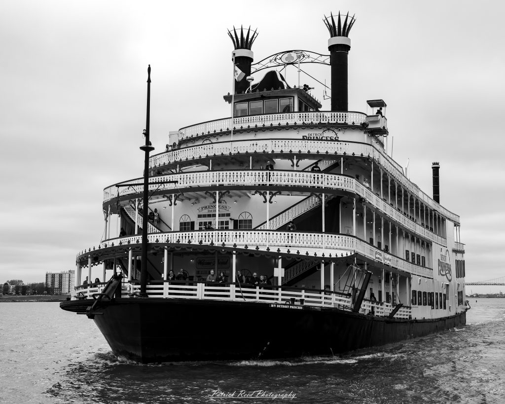 Black and white street photography in downtown Detroit, Michigan capturing urban architecture, city life, public art, and Detroit riverfront scenes in a documentary photography style.
