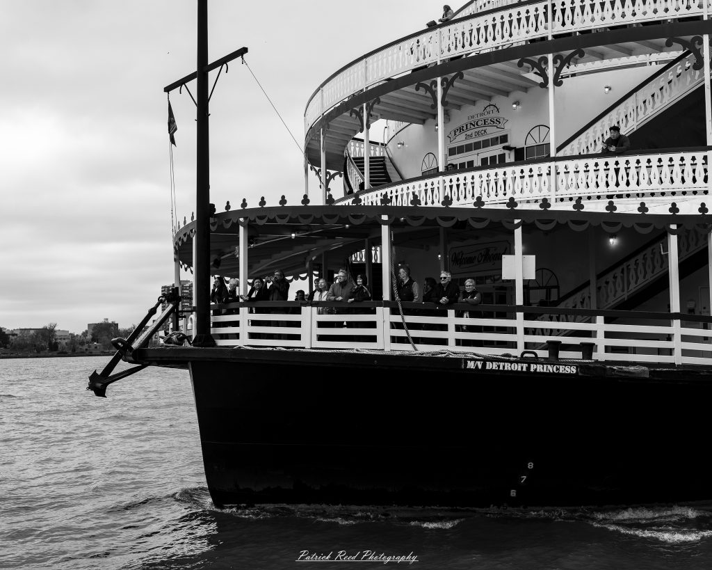 Black and white street photography in downtown Detroit, Michigan capturing urban architecture, city life, public art, and Detroit riverfront scenes in a documentary photography style.