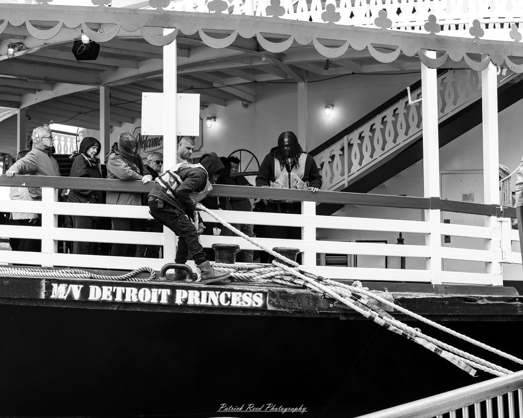 Black and white street photography in downtown Detroit, Michigan capturing urban architecture, city life, public art, and Detroit riverfront scenes in a documentary photography style.