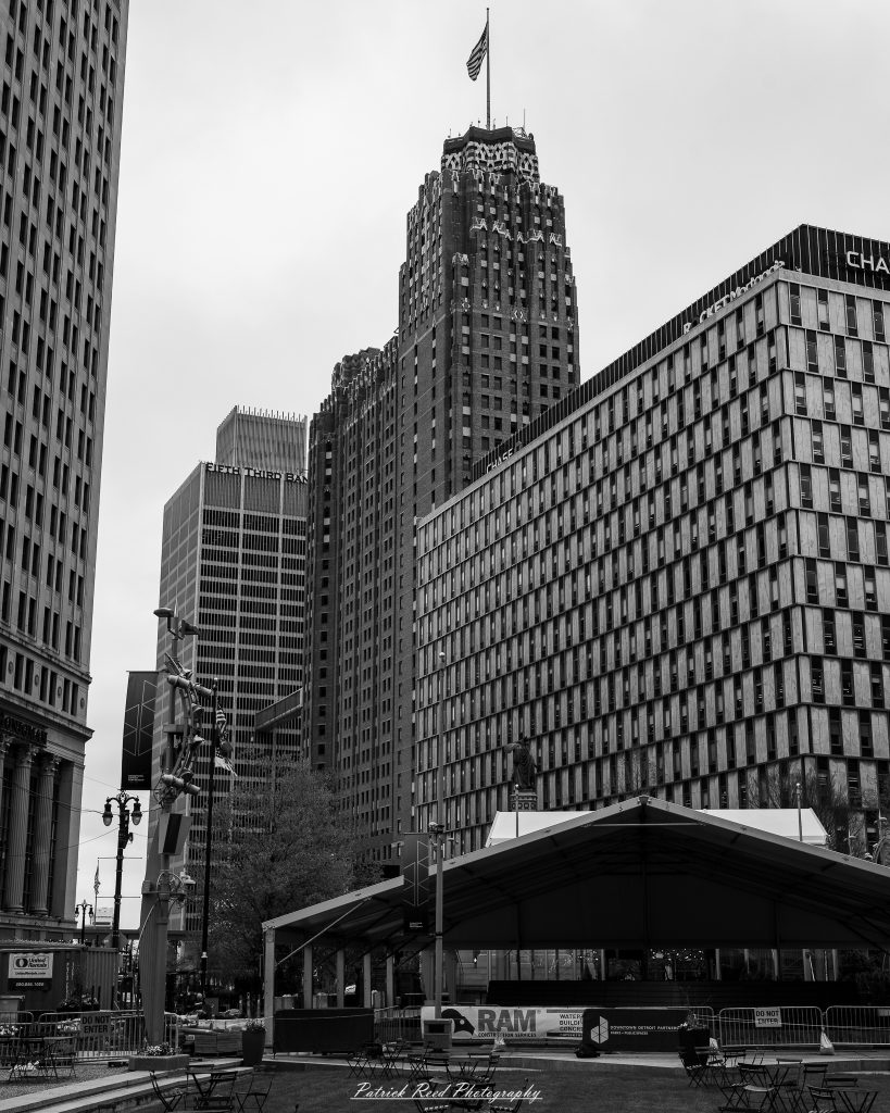 Black and white street photography in downtown Detroit, Michigan capturing urban architecture, city life, public art, and Detroit riverfront scenes in a documentary photography style.