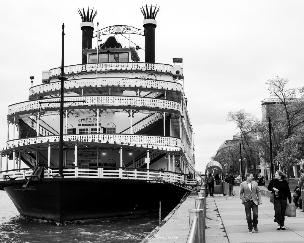 Black and white street photography in downtown Detroit, Michigan capturing urban architecture, city life, public art, and Detroit riverfront scenes in a documentary photography style.