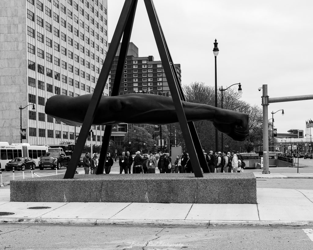 Black and white street photography in downtown Detroit, Michigan capturing urban architecture, city life, public art, and Detroit riverfront scenes in a documentary photography style.