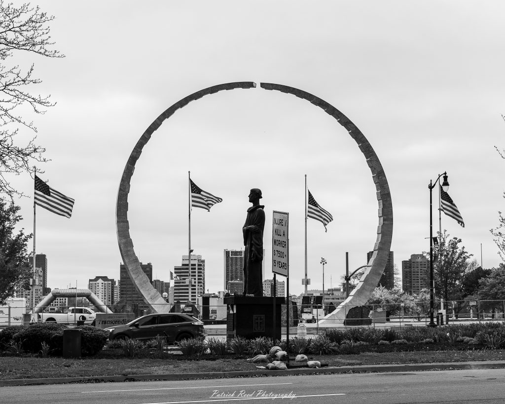 Black and white street photography in downtown Detroit, Michigan capturing urban architecture, city life, public art, and Detroit riverfront scenes in a documentary photography style.