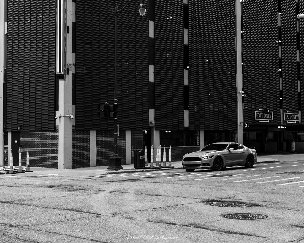 Black and white street photography in downtown Detroit, Michigan capturing urban architecture, city life, public art, and Detroit riverfront scenes in a documentary photography style.