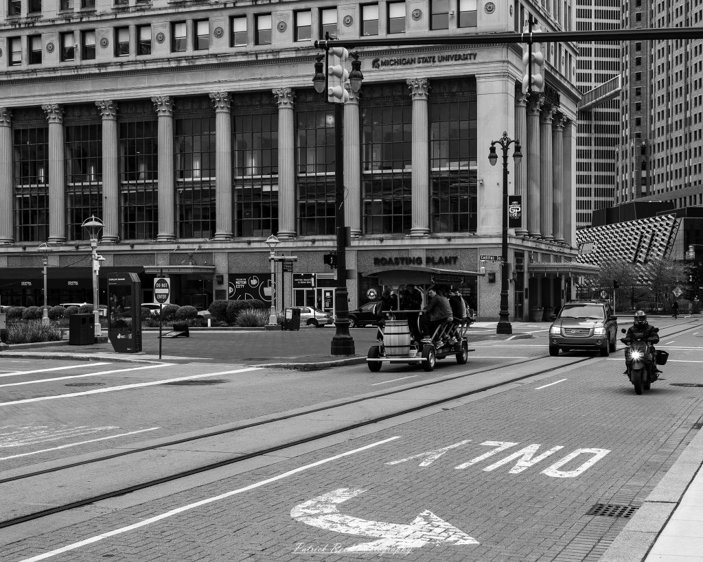 Black and white street photography in downtown Detroit, Michigan capturing urban architecture, city life, public art, and Detroit riverfront scenes in a documentary photography style.