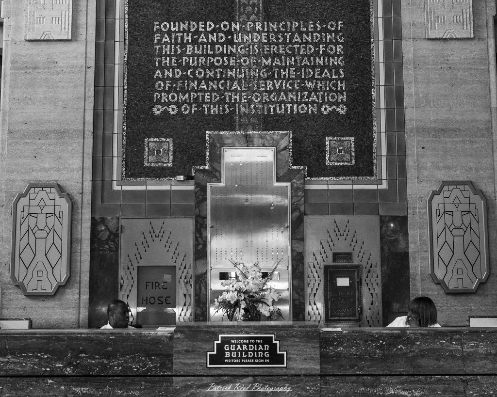 Black and white street photography in downtown Detroit, Michigan capturing urban architecture, city life, public art, and Detroit riverfront scenes in a documentary photography style.