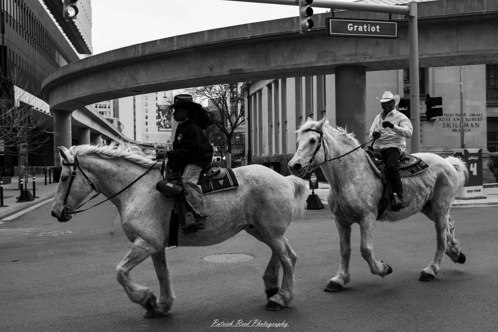 Black and white street photography in downtown Detroit, Michigan capturing urban architecture, city life, public art, and Detroit riverfront scenes in a documentary photography style.