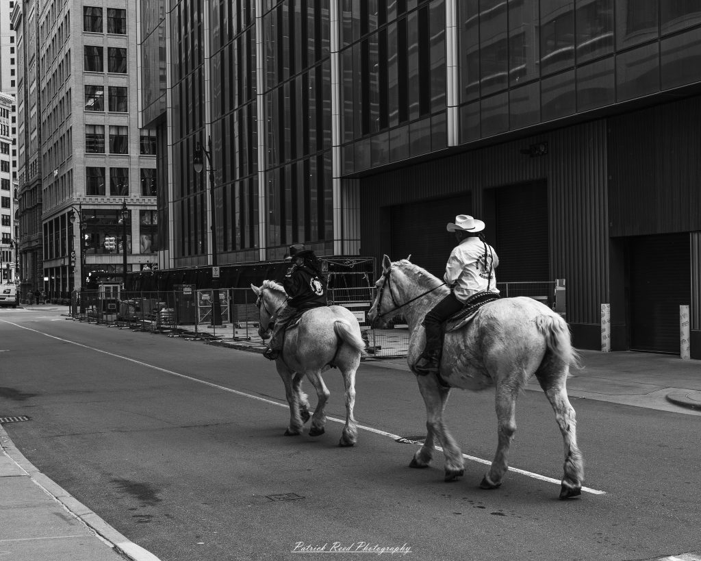 Black and white street photography in downtown Detroit, Michigan capturing urban architecture, city life, public art, and Detroit riverfront scenes in a documentary photography style.