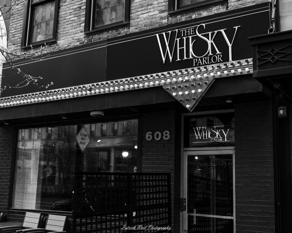 Black and white street photography in downtown Detroit, Michigan capturing urban architecture, city life, public art, and Detroit riverfront scenes in a documentary photography style.