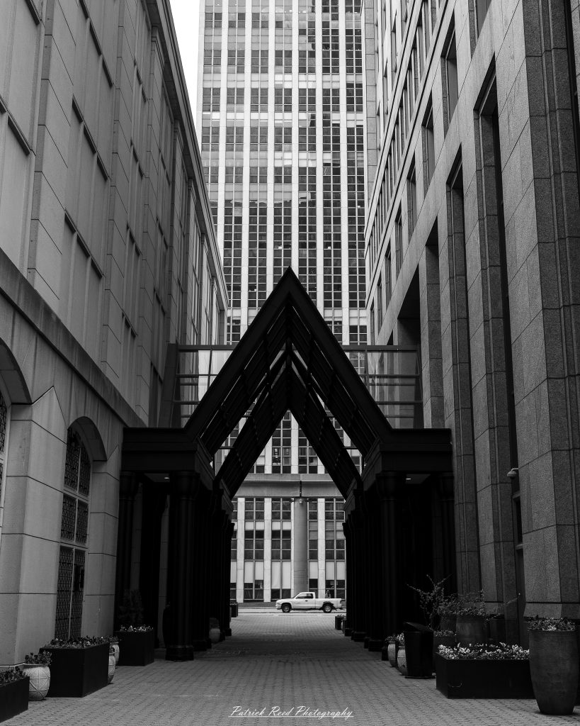Black and white street photography in downtown Detroit, Michigan capturing urban architecture, city life, public art, and Detroit riverfront scenes in a documentary photography style.