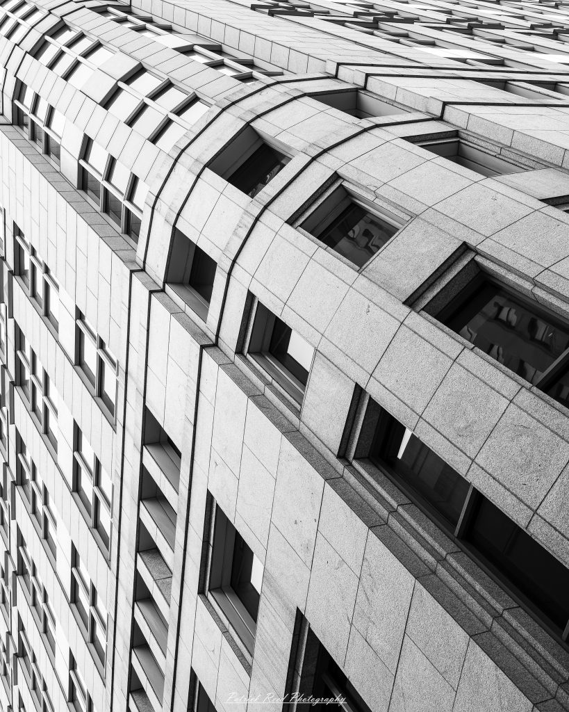 Black and white street photography in downtown Detroit, Michigan capturing urban architecture, city life, public art, and Detroit riverfront scenes in a documentary photography style.