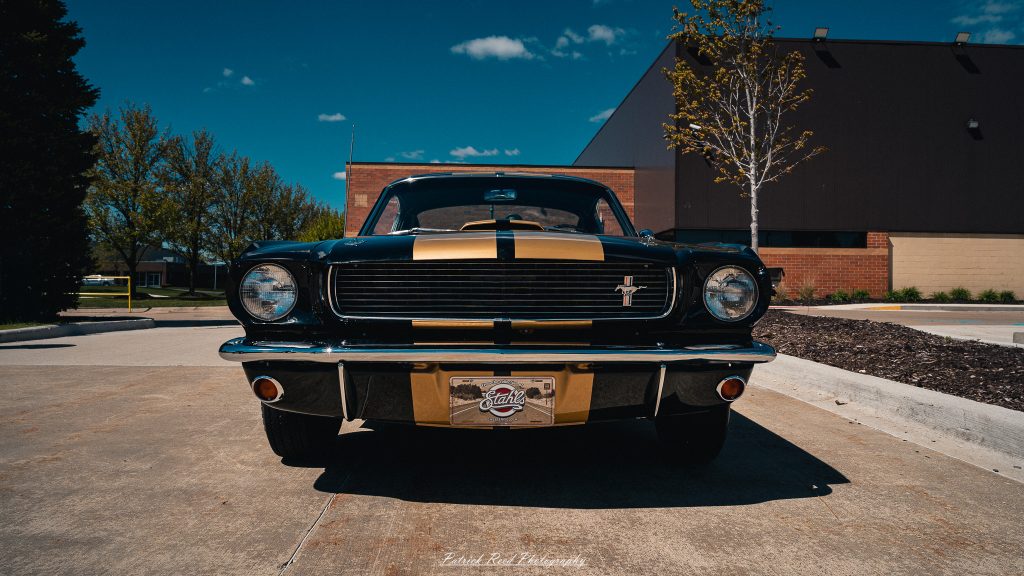 Classic car photography from a Michigan car show featuring vintage muscle cars, hot rods, classic trucks, and automotive detail shots captured in a cinematic documentary style.