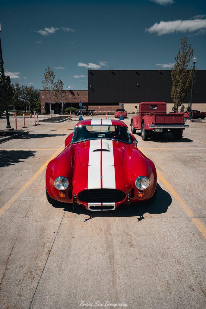 Classic car photography from a Michigan car show featuring vintage muscle cars, hot rods, classic trucks, and automotive detail shots captured in a cinematic documentary style.