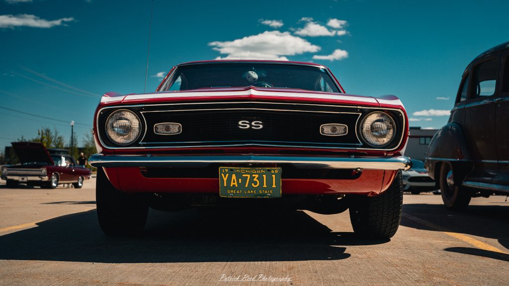 Classic car photography from a Michigan car show featuring vintage muscle cars, hot rods, classic trucks, and automotive detail shots captured in a cinematic documentary style.