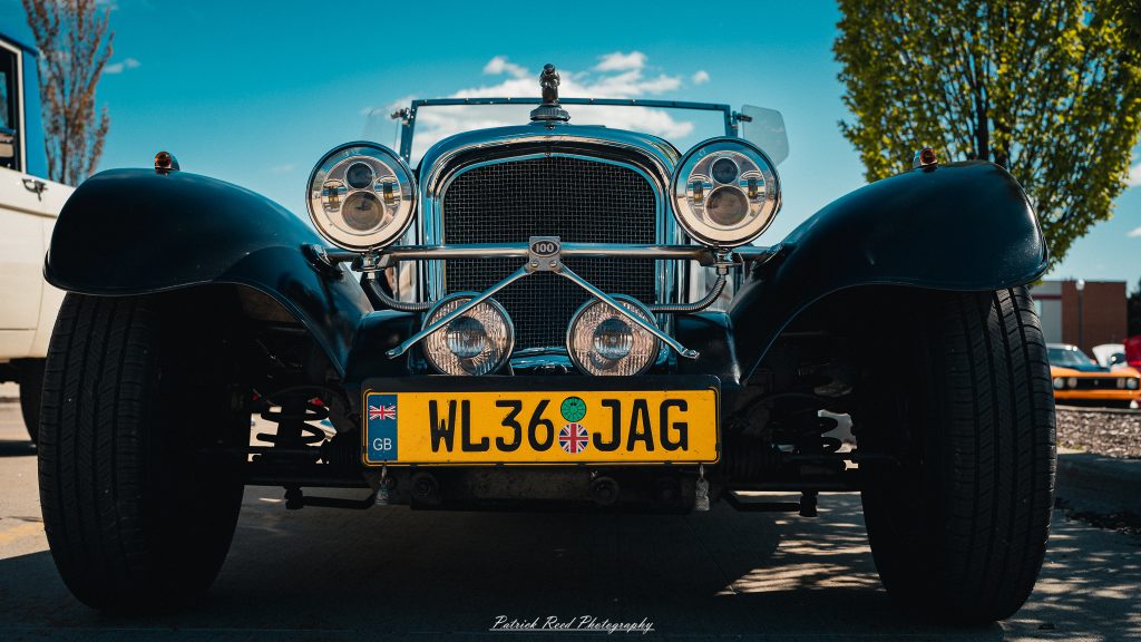 Classic car photography from a Michigan car show featuring vintage muscle cars, hot rods, classic trucks, and automotive detail shots captured in a cinematic documentary style.