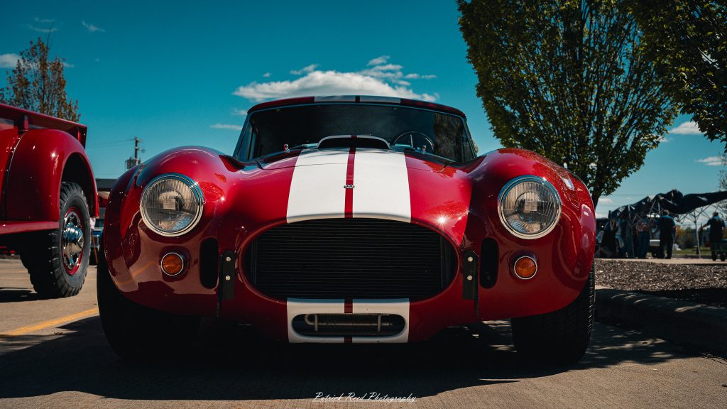 Classic car photography from a Michigan car show featuring vintage muscle cars, hot rods, classic trucks, and automotive detail shots captured in a cinematic documentary style.