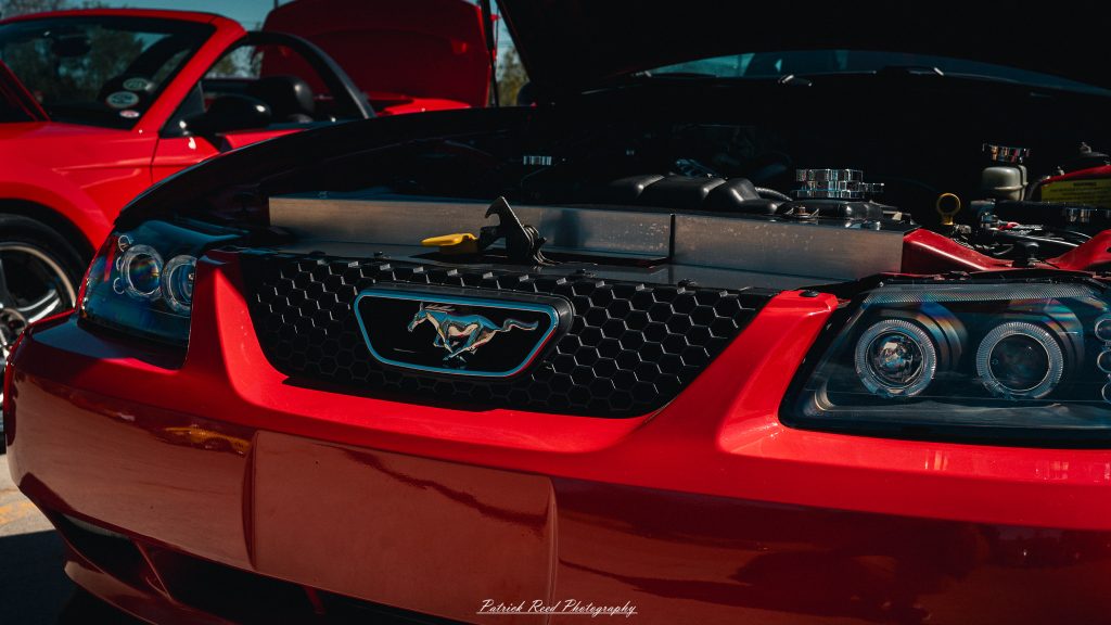 Classic car photography from a Michigan car show featuring vintage muscle cars, hot rods, classic trucks, and automotive detail shots captured in a cinematic documentary style.