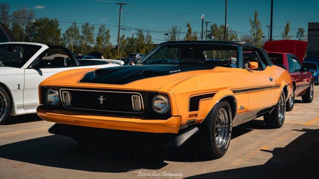 Classic car photography from a Michigan car show featuring vintage muscle cars, hot rods, classic trucks, and automotive detail shots captured in a cinematic documentary style.