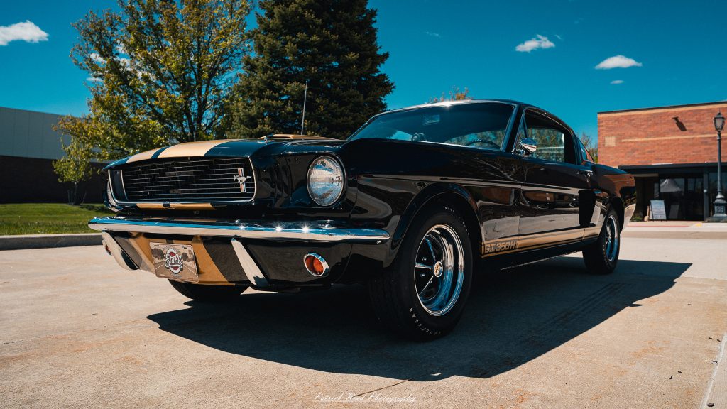 Classic car photography from a Michigan car show featuring vintage muscle cars, hot rods, classic trucks, and automotive detail shots captured in a cinematic documentary style.