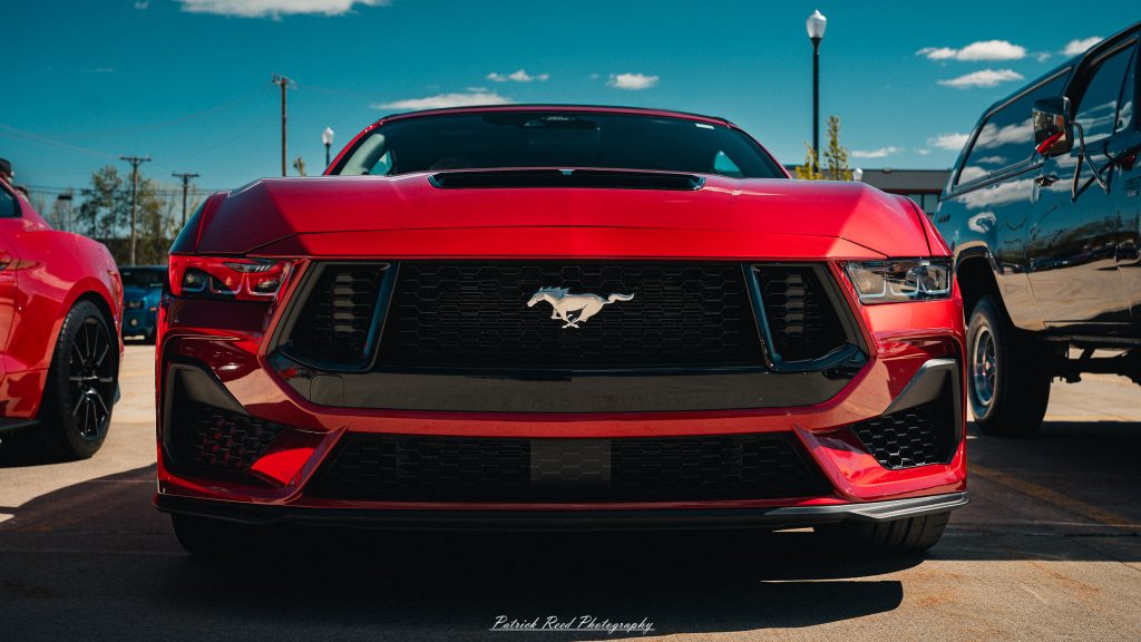 Classic car photography from a Michigan car show featuring vintage muscle cars, hot rods, classic trucks, and automotive detail shots captured in a cinematic documentary style.