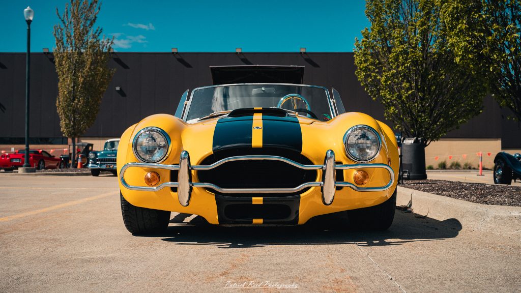 Classic car photography from a Michigan car show featuring vintage muscle cars, hot rods, classic trucks, and automotive detail shots captured in a cinematic documentary style.