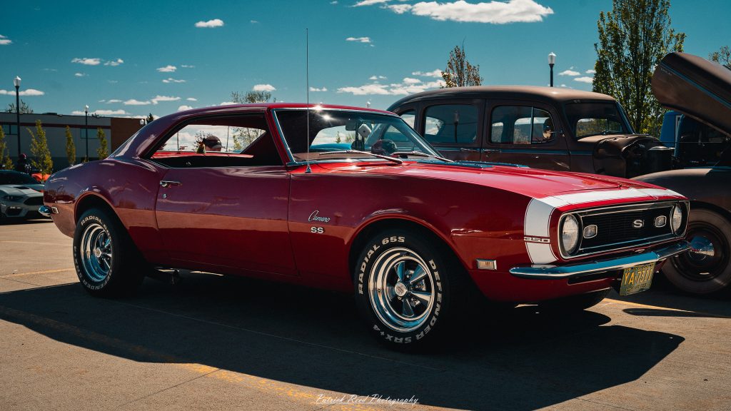 Classic car photography from a Michigan car show featuring vintage muscle cars, hot rods, classic trucks, and automotive detail shots captured in a cinematic documentary style.