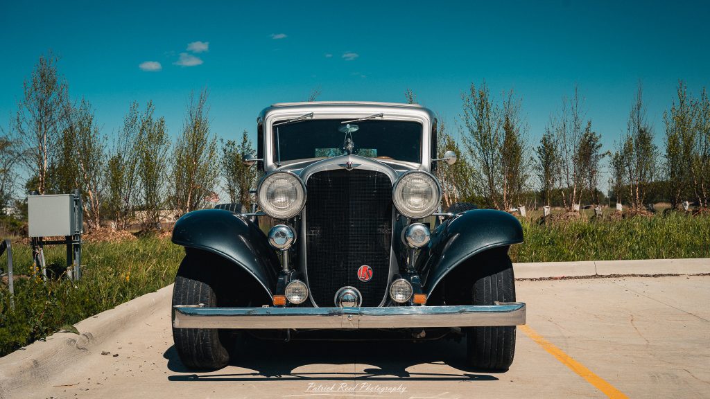 Classic car photography from a Michigan car show featuring vintage muscle cars, hot rods, classic trucks, and automotive detail shots captured in a cinematic documentary style.