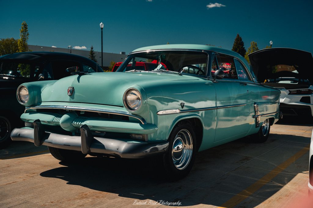 Classic car photography from a Michigan car show featuring vintage muscle cars, hot rods, classic trucks, and automotive detail shots captured in a cinematic documentary style.