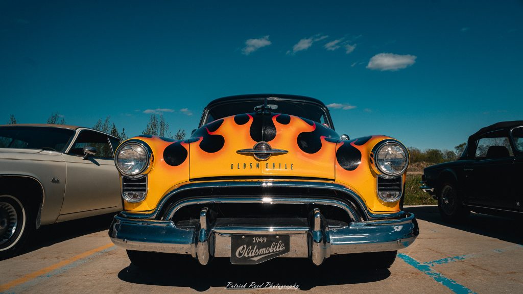 Classic car photography from a Michigan car show featuring vintage muscle cars, hot rods, classic trucks, and automotive detail shots captured in a cinematic documentary style.