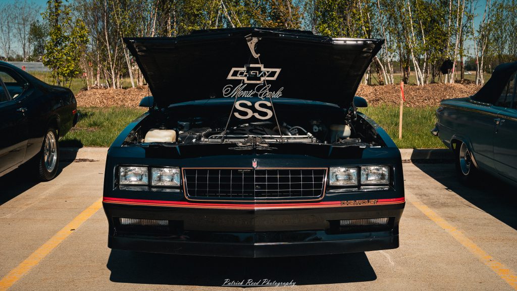 Classic car photography from a Michigan car show featuring vintage muscle cars, hot rods, classic trucks, and automotive detail shots captured in a cinematic documentary style.